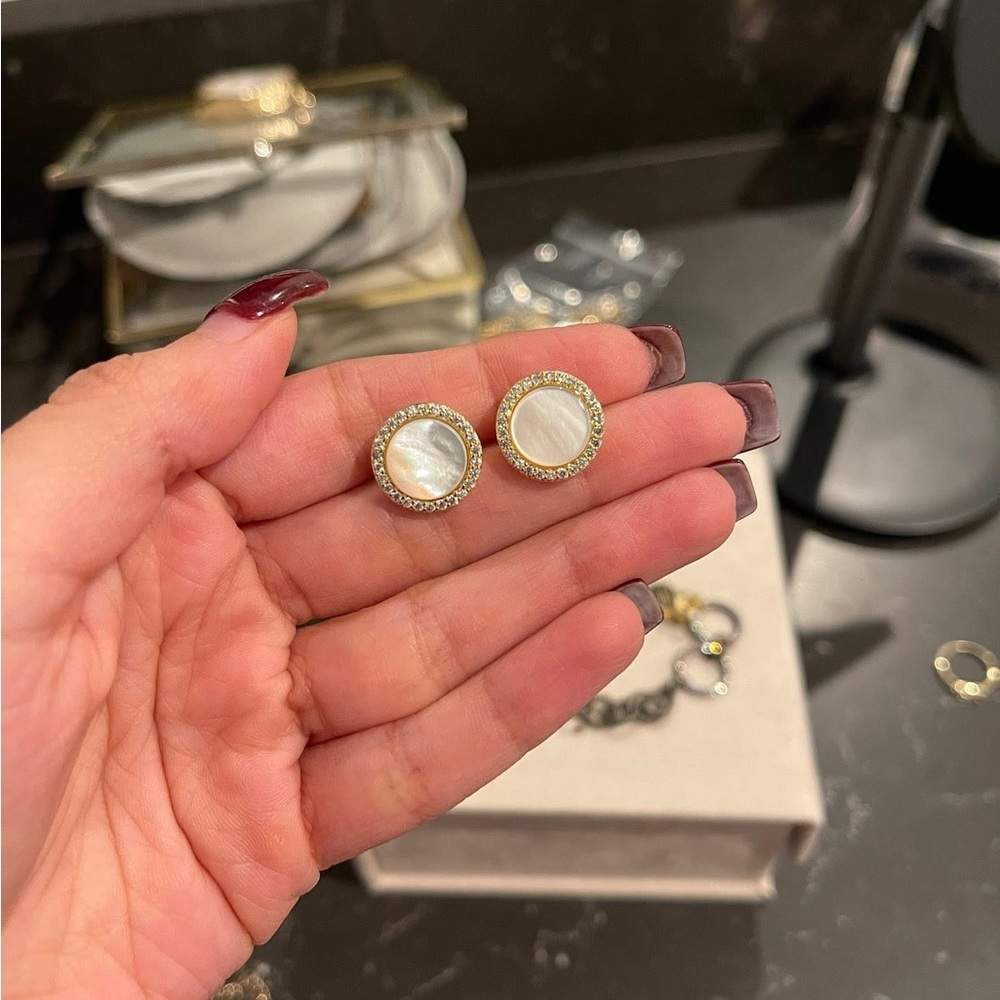 Freida Rothman Vault earrings. Round mother of pearl center w/pave around it.